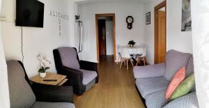 a living room with a couch and chairs and a table at Ricardo Hostal Apartamento in Alicante
