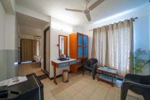 a bathroom with a vanity and a mirror in a room at Olive Zip Calangute Mira by Embassy Group in Calangute