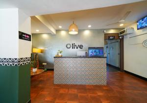 a lobby with a bar with a live sign on the wall at Olive Zip Calangute Mira by Embassy Group in Calangute