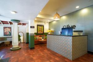 a lobby with a bar with a couch in a room at Olive Zip Calangute Mira by Embassy Group in Calangute