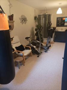 a room with a gym with exercise equipment in it at l'Oppidum in Châteauneuf-du-Rhône