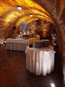 a restaurant with two tables with plates on them in a cave at Landhotel Thürmchen in Schirgiswalde