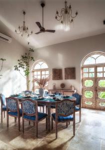 a dining room with a table and chairs at LohonoStays Calisto Villa E in Camorlim