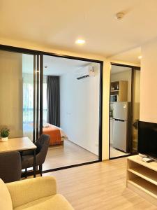 a living room with a sliding glass door leading to a bedroom at Dcondo Reef Serenity Condo 2 in Phuket