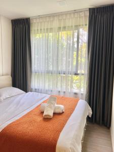 a bedroom with a bed with two towels on it at Dcondo Reef Serenity Condo 2 in Phuket +17 photos