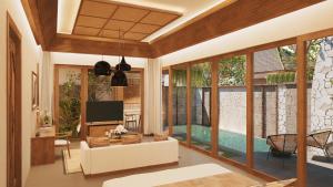 a living room with a tv and large windows at Avala Nusa Dua Bali in Bali Nusa Dua