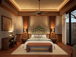 a bedroom with a large bed and a desk at Avala Nusa Dua Bali in Bali Nusa Dua