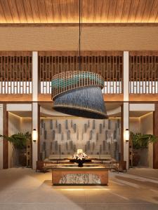 a large lobby with a large light fixture and a fountain at Avala Nusa Dua Bali in Bali Nusa Dua
