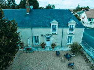 an aerial view of a white house with a roof at Chouette Nuit in Thenay