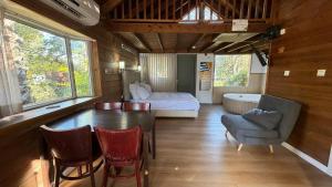 a room with a table and a bed and a bedroom at Nofey HaBashan Country Lodge in Lahavot HaBashan