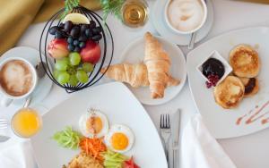 a table with plates of food and cups of coffee at Hotel Park in Čakovec +33 photos