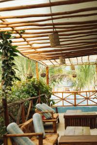 a patio with chairs and a wooden pergola at Kidoti Bay in Kidoti