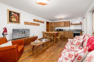 a living room with a couch and a table at Maison Carrel Elegant 6 in Breuil-Cervinia