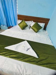 a bed with a towel on top of it at Hotel ANR Grand in Visakhapatnam