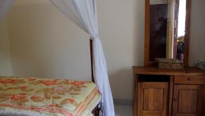 Postel nebo postele na pokoji v ubytování Arya Homestay