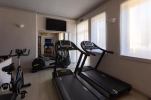 a gym with two exercise bikes and a treadmill at Hotel Gialletti in Orvieto