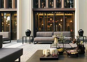 a living room with a couch in a building at Shanghai Qiuzhu Hotel - Near Shanghai Disney Resort & Wildlife Park - Free Buffet Breakfast - Pick-up Service for Disneyland, PVG Airport, Wildlife Park & Xinchang Metro Station in Shanghai