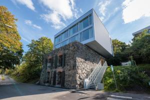a building with a staircase on the side of a road at Modern Studios within Ancient Ruins in Stockholm