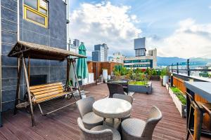 a balcony with a table and chairs on a building at Hotel Campanella in Seoul