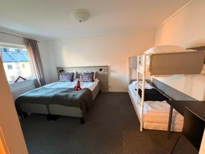 a small bedroom with a bunk bed and a bunk bed at Fridhemsgatan City Stay in Mora +4 photos