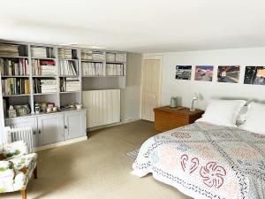 a bedroom with a bed and book shelves at The Artist's House in Norwich
