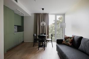 a living room with a couch and a table at Modern Studios within Ancient Ruins in Stockholm