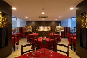 a dining room with red tables and chairs at Hotel Gialletti in Orvieto