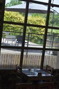 a table and chairs in a room with a large window at Carpe Diem 3 in Goutrens