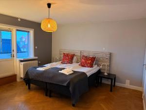 a bedroom with a bed with two pillows on it at Fridhemsgatan City Stay in Mora