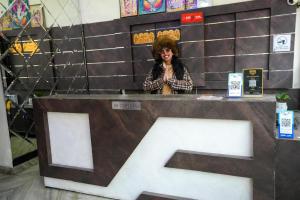 a woman standing behind a counter in a store at Hotel Blessing Inn in Jalandhar