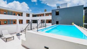 a swimming pool in the backyard of a building at Luxury Apartment Unit 101 in George