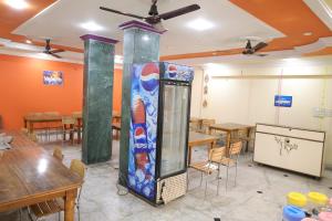 a dining room with tables and a water dispenser at New Samrat Hotel & Restaurant in Srīnagar