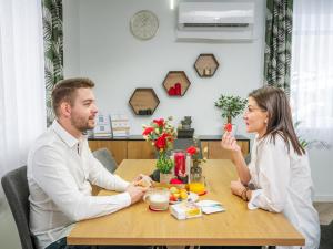 a man and woman sitting at a table at Vadvirág 5 by DunaVibe in Baja