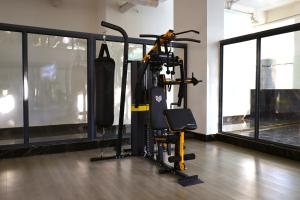 a gym with a elliptical machine in a room with windows at GBSL Grand Villa in Nairobi