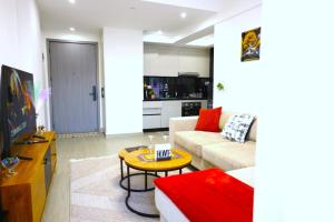 a living room with a couch and a table at GBSL Grand Villa in Nairobi