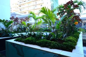 a garden in a building with palm trees and plants at GBSL Grand Villa in Nairobi