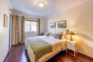 a bedroom with a large bed and a window at Ocean Lido in Funchal