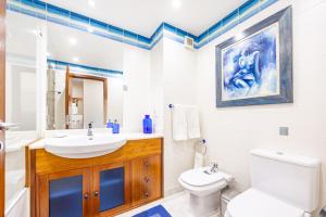 a bathroom with a sink and a toilet at Ocean Lido in Funchal +82 photos
