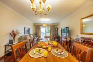 a dining room and living room with a table and chairs at Ocean Lido in Funchal