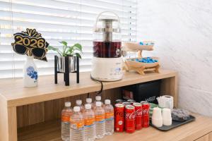 a blender sitting on a shelf with bottles of water at Amrise Hotel Kitchener in Singapore