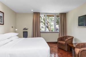 a hotel room with a bed and a window at Best Western Nairobi Upper Hill in Nairobi +258 photos
