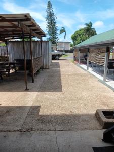 a parking lot with a picnic table and a building at GRAND CENTRAL HOTEL PROSERPINE in Proserpine