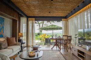 a living room with a couch and a table at Plataran Borobudur in Borobudur