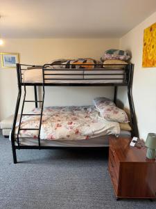 two bunk beds in a room with a table at Warm, Sleeps 6, Bathroom, Beaches Shops Cafes Bars Pier, Central Ryde in Ryde
