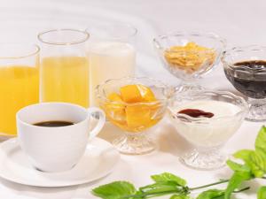 a table with glasses of juice and a cup of coffee at Court Hotel Niigata in Niigata