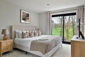 a bedroom with a bed and a large window at Finest Retreats - Orchard Rise in Bude