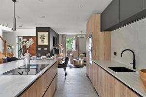 a kitchen with a counter and a living room at Finest Retreats - Orchard Rise in Bude