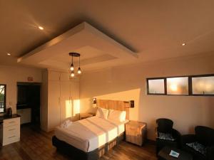 a hotel room with a bed and a chair at Van Gogh - Zur See in Ballito