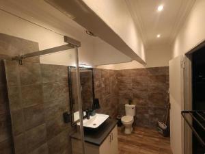 a bathroom with a sink and a toilet at Van Gogh - Zur See in Ballito +8 photos