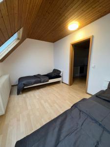 a large room with two beds and a window at Monteurzimmer Schäfer - Rhein Main in Hösbach